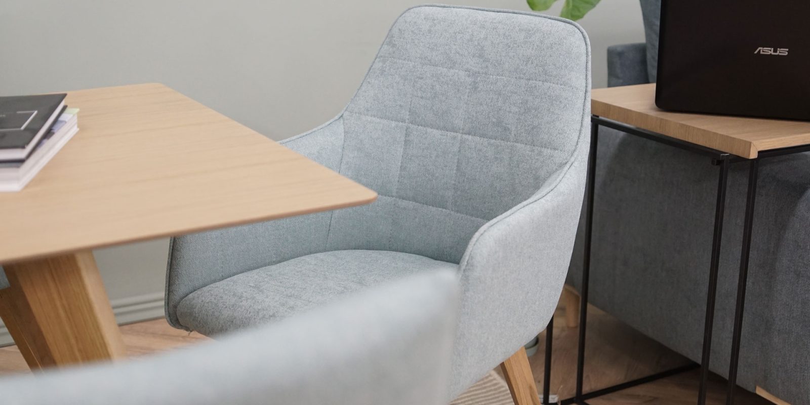 detail modern dining chair with armrest in mint upholstery and oak legs