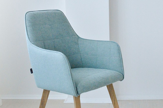 detail modern dining chair with armrest in mint upholstery and oak legs