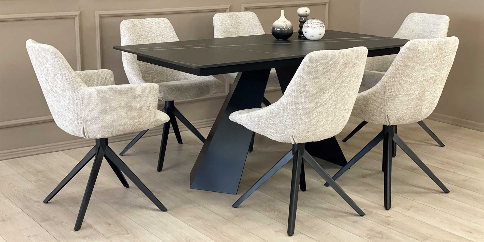 Armchair Asya with black metal legs and beige upholstery on black dining table with Laminam top