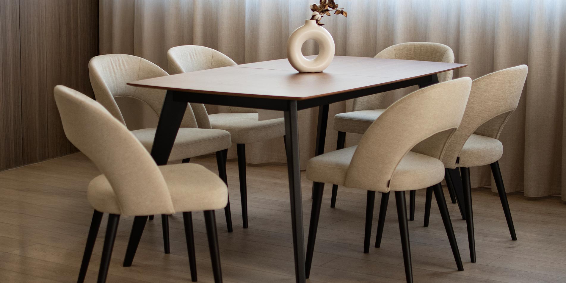 Dining chairs Aurora with black wooden legs and cream upholstery. 
