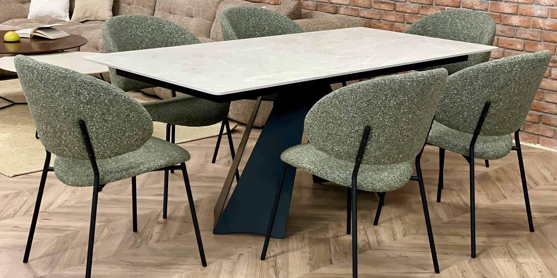 Dining table Cassini with white tabletop from Laminam and black metal legs and green chairs