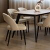 Dining chairs Aurora with black wooden legs and cream upholstery.