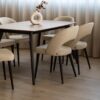 Dining chairs Aurora with black wooden legs and cream upholstery.