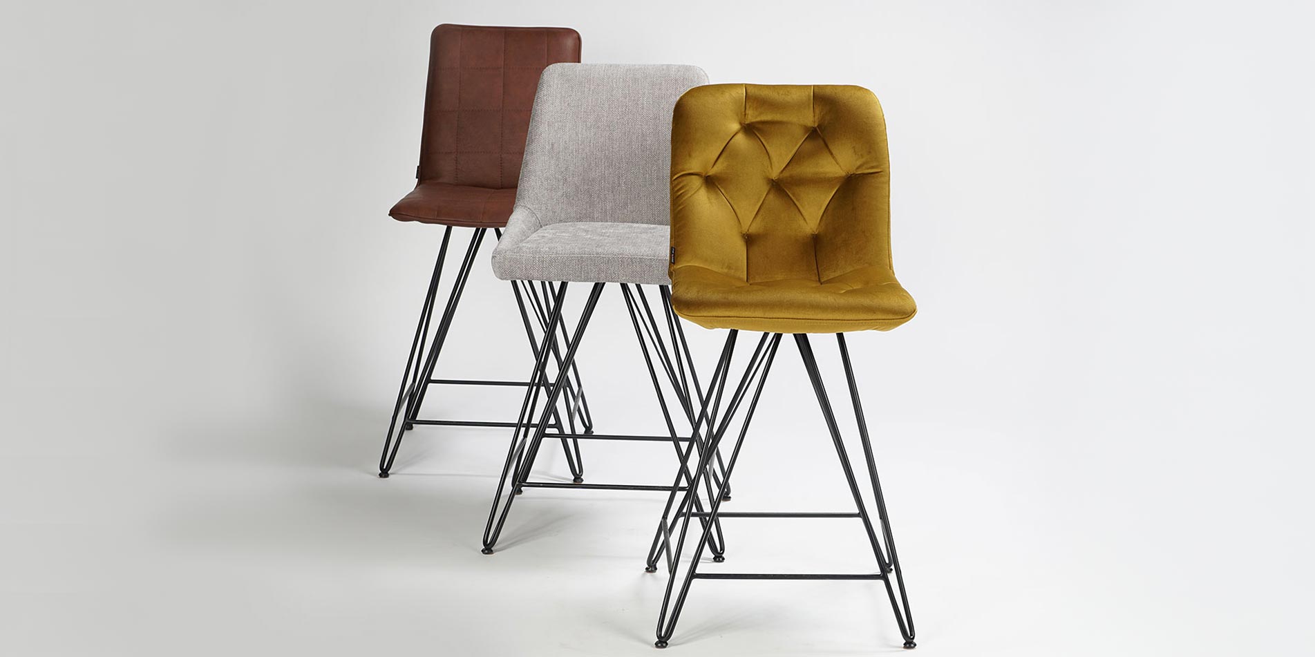 Bar chairs with black metal legs and yellow velvet