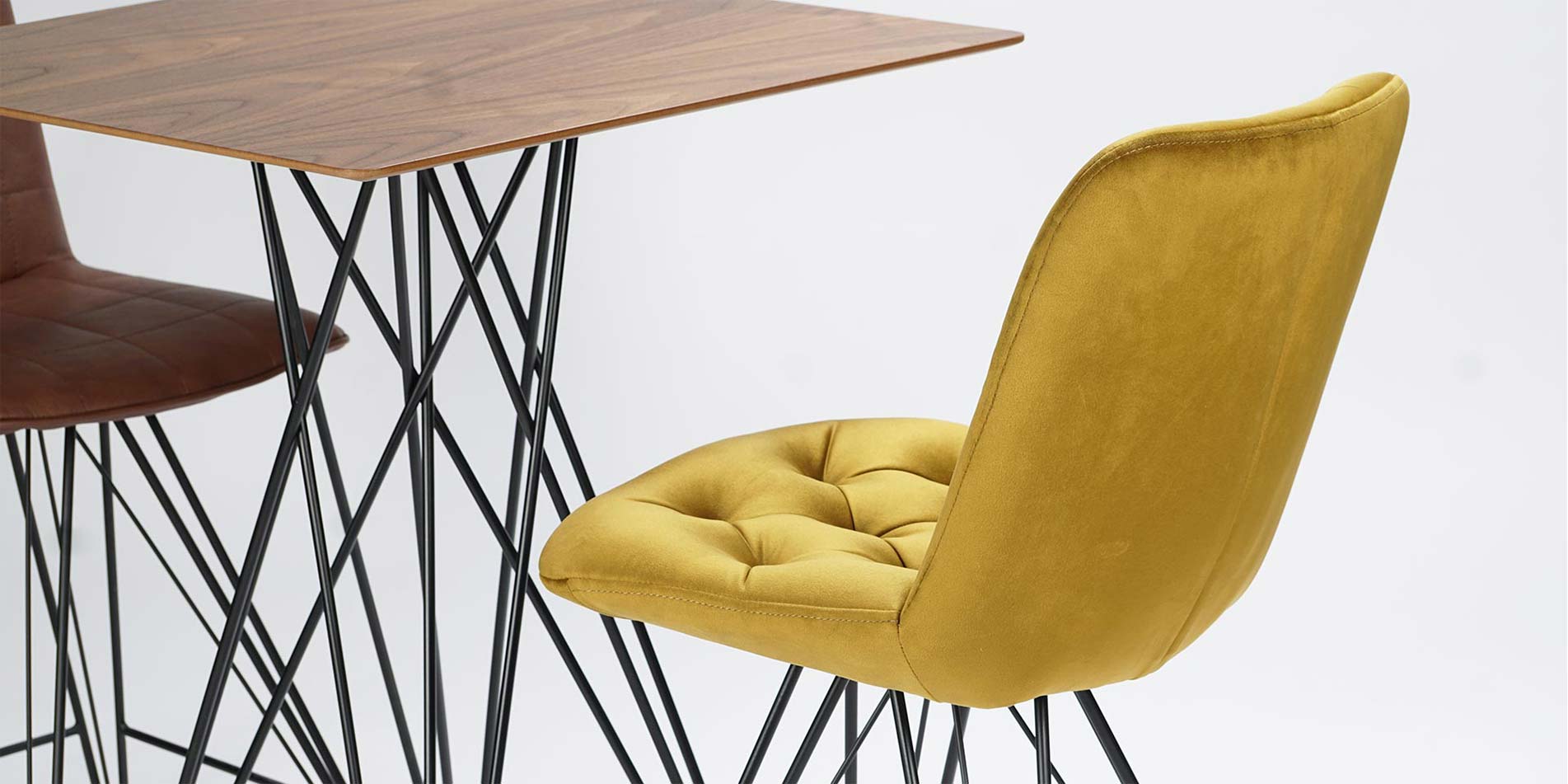 Bar chairs with black metal legs and yellow velvet