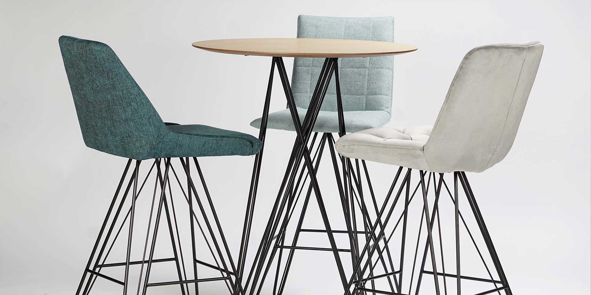 Bar chairs with black metal legs and mint upholstery on round bar table