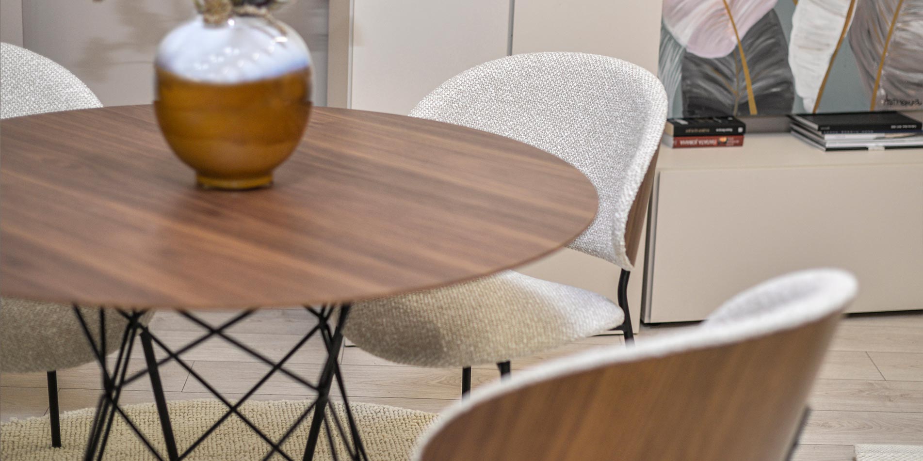 Dining chair with walnut veneer back and beige upholstery.