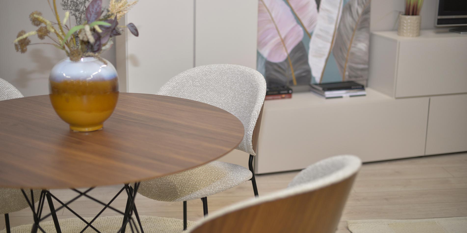 Dining chair with walnut veneer back and beige upholstery.