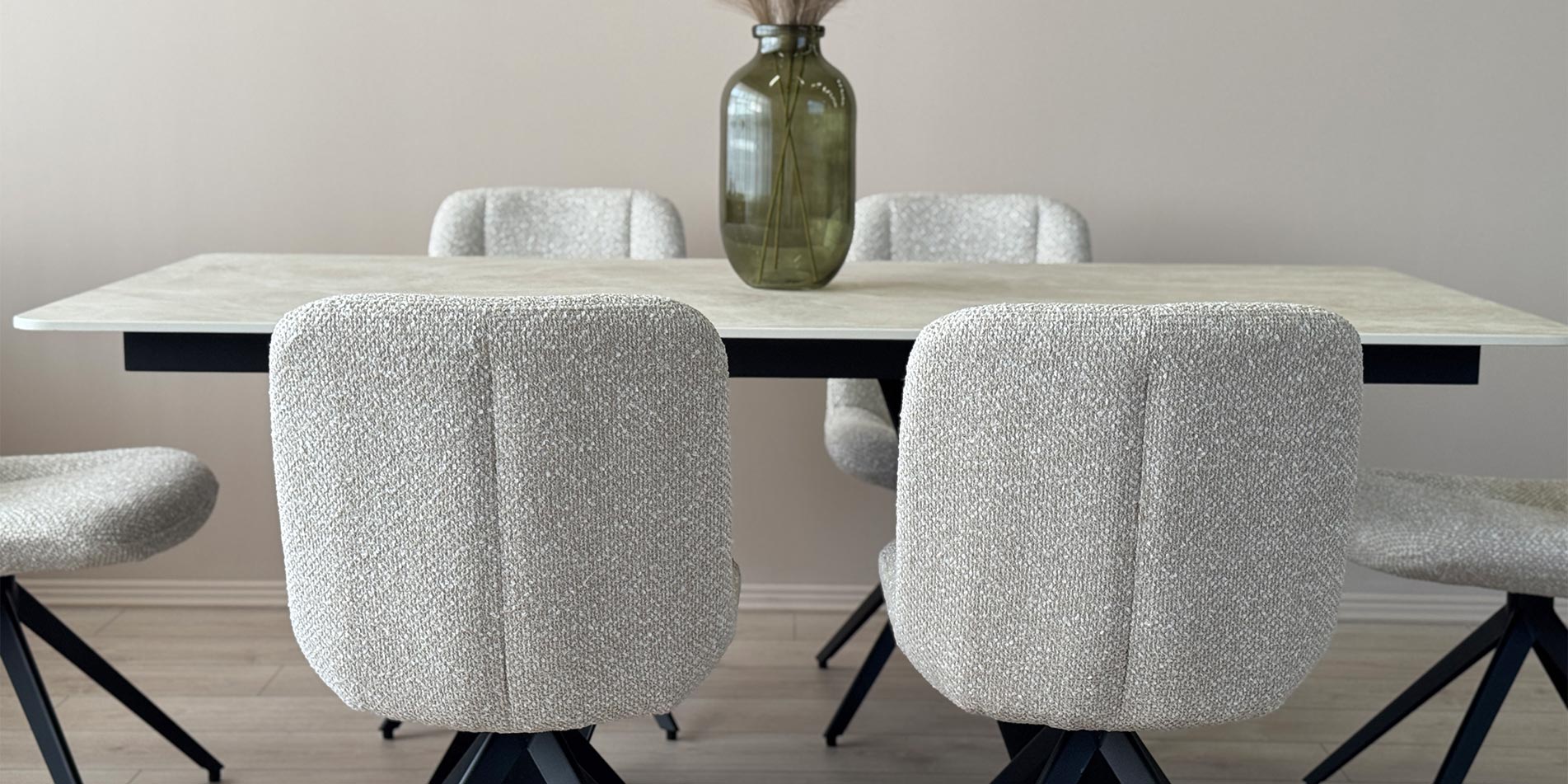 Dining chair black metal legs on dining table with cream Laminam table top.