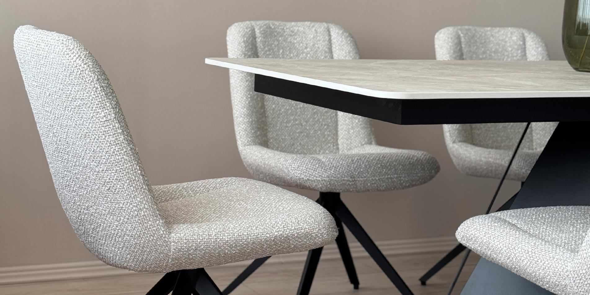 Dining chair black metal legs on dining table with cream Laminam table top.