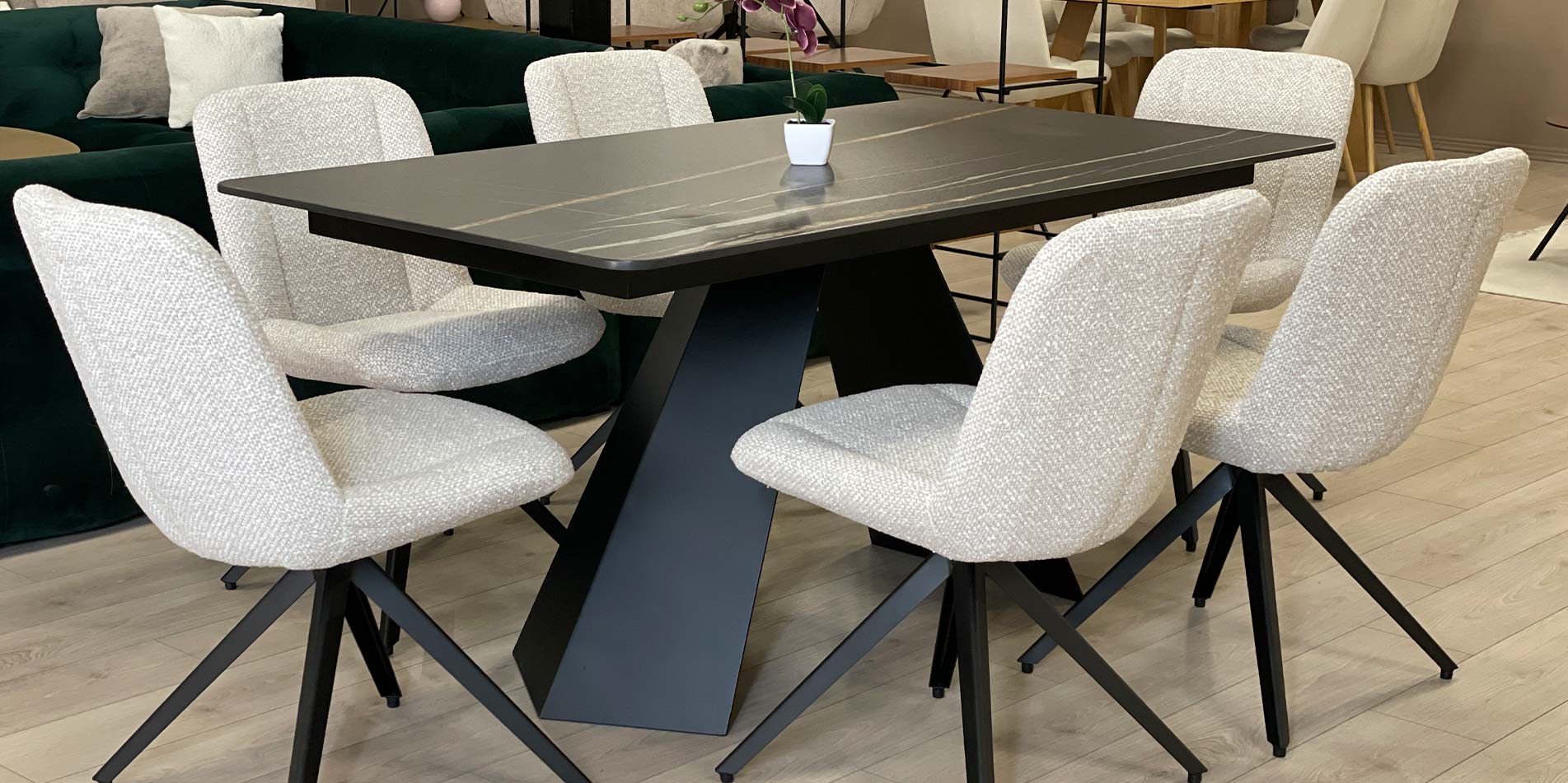 Dining chair black metal legs on dining table with black Laminam table top.