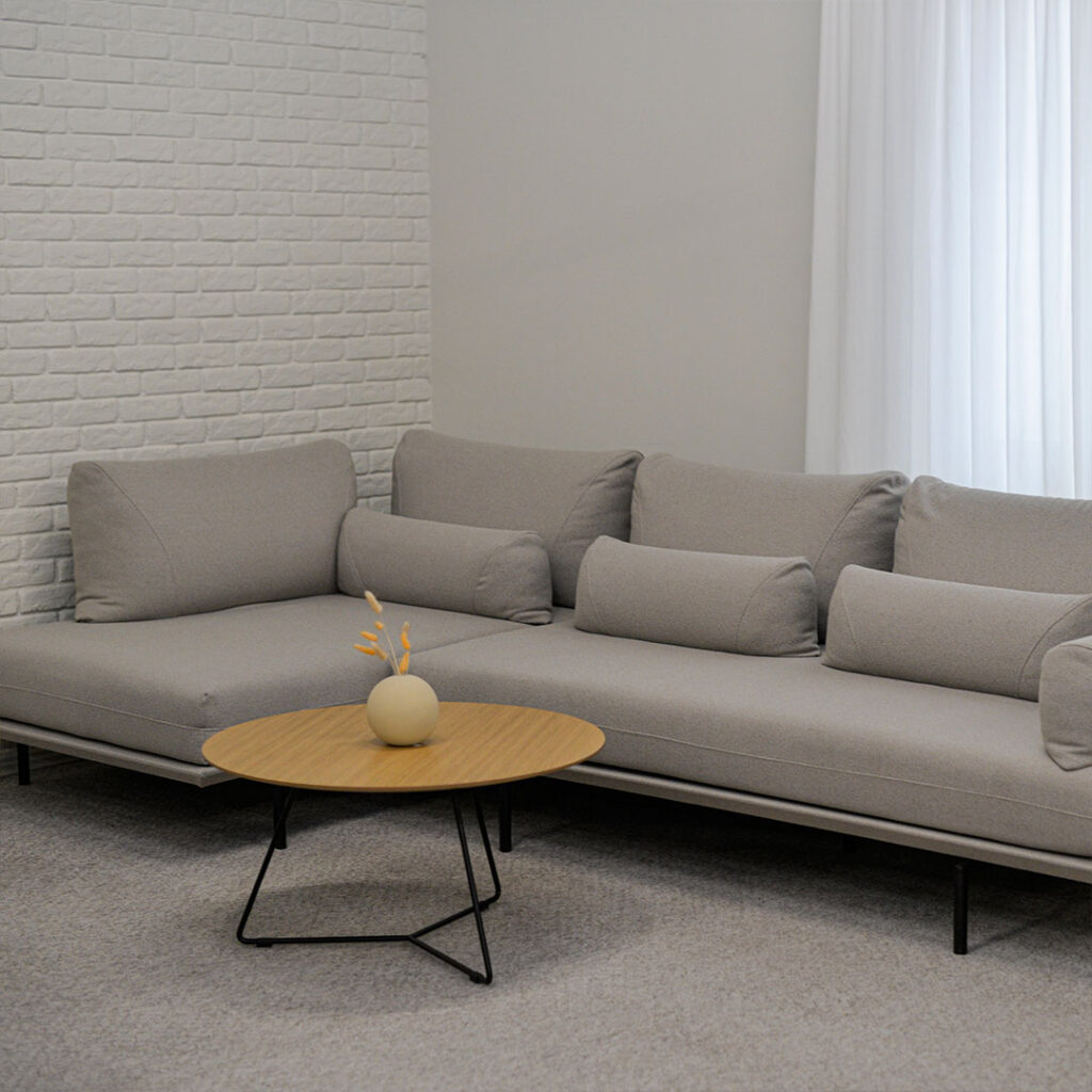 Sofa Bella in grey upholstery, with mobile pillows arrange in modular sofa.