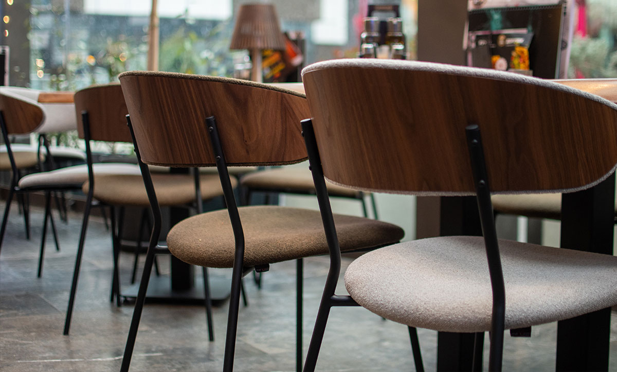 Dining chairs Oasis with walnut veneer in back, in sports bar.