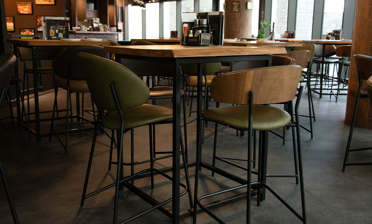 Bar chairs in green upholstery in Sport Beer Garden.