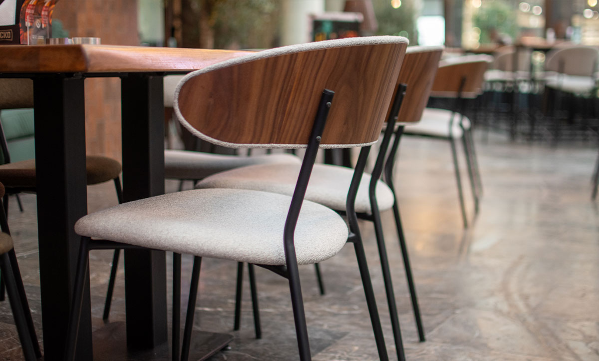 Dining chairs Oasis with walnut veneer in back, in sports bar.