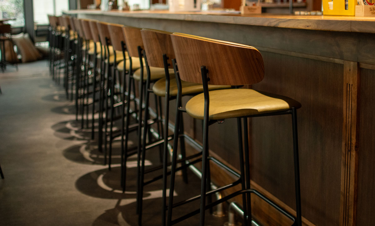 Bar chairs Oasis with walnut veneer in back, in sports bar.