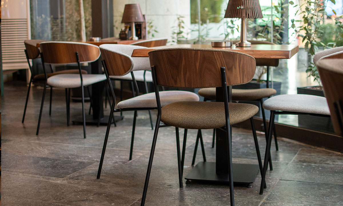 Dining chairs Oasis with walnut veneer in back, in sports bar.