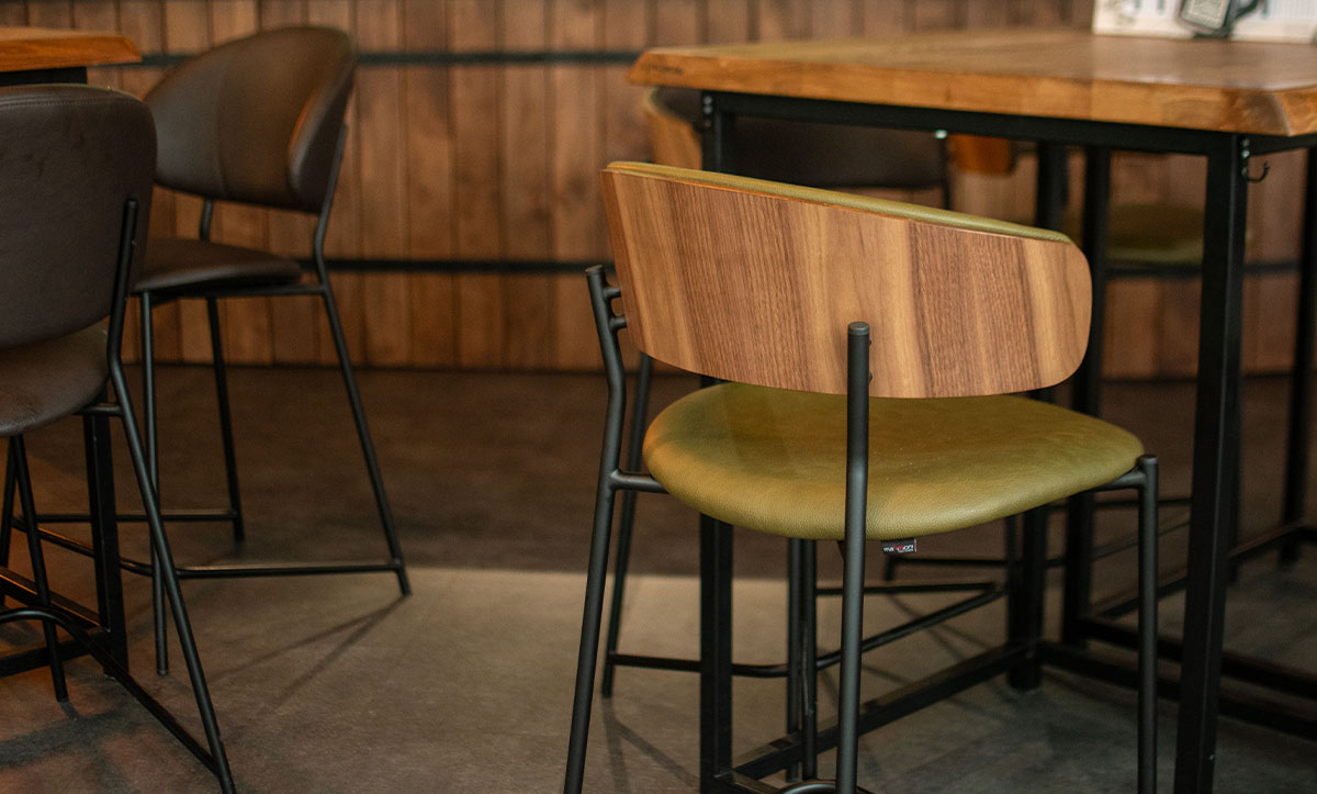 Bar chairs Oasis with walnut veneer in back, in sports bar.