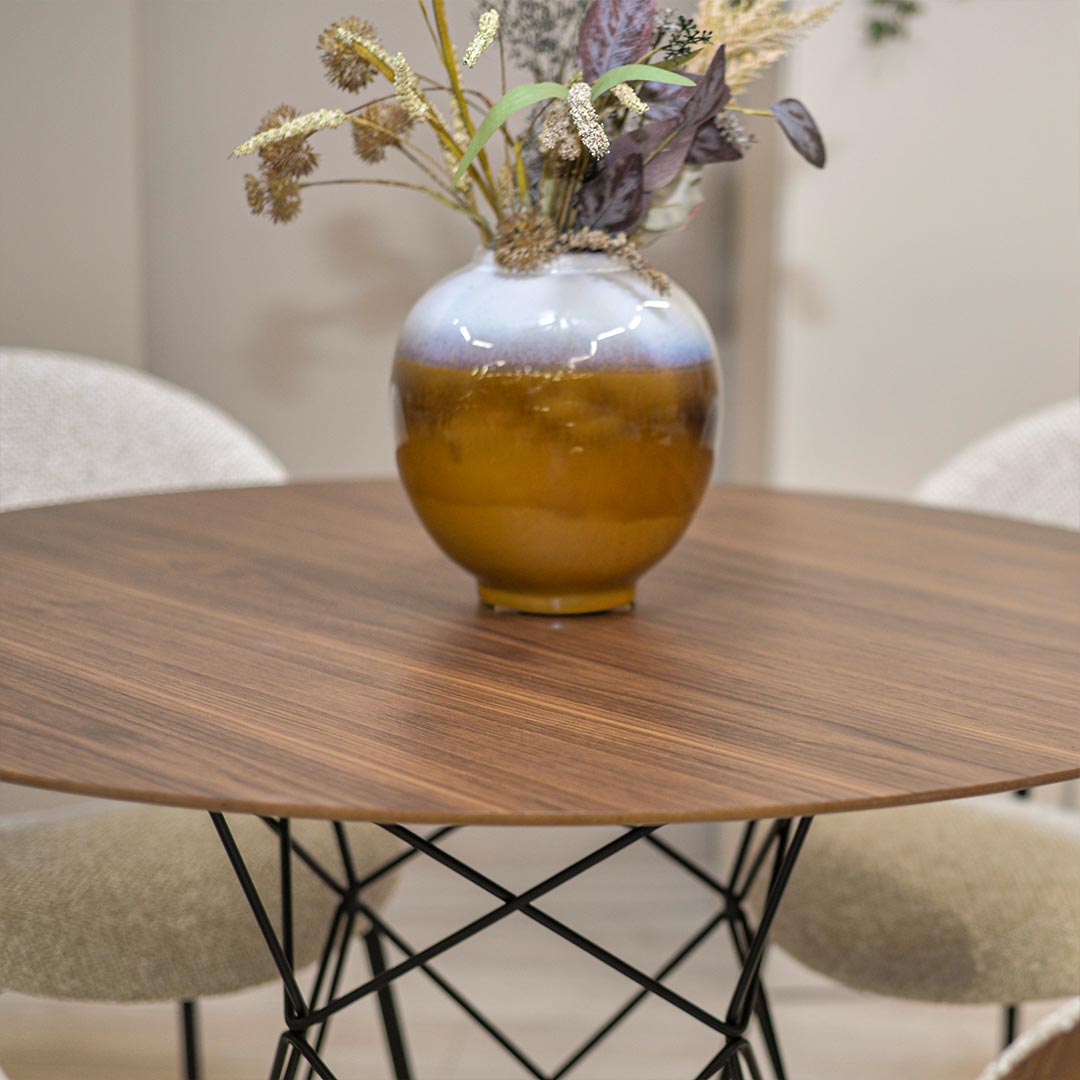 Round dining table with walnut table top and black metal legs