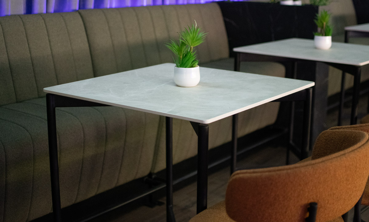 Bar table with ceramic table top in white and black metal legs by Mahagoni Furniture.