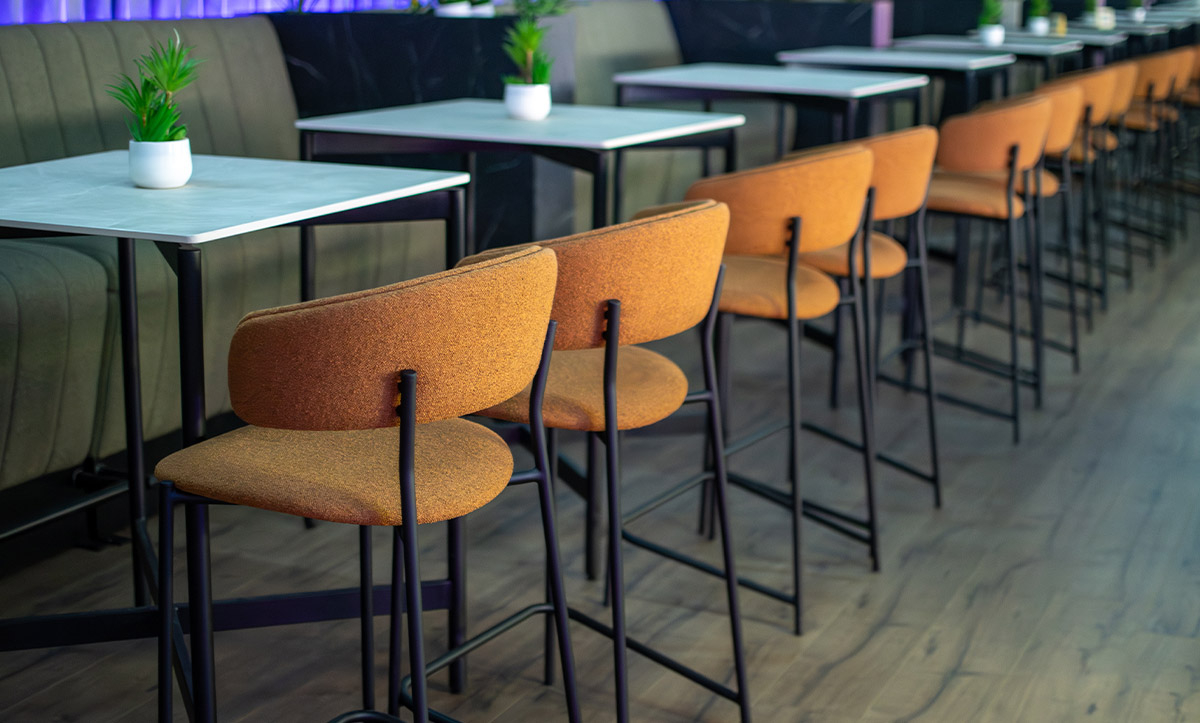 Bar chairs in orange upholstery in coffee bar in Kumanovo.