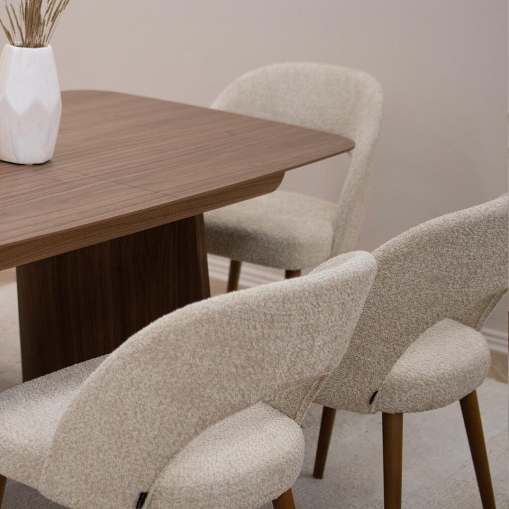 Tрпезариска маса Сфера од орев со две неправилно обликувани дрвени ногарки.