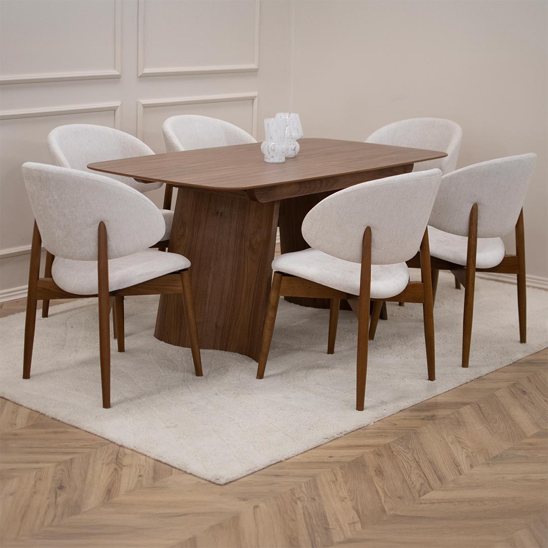 Dining set with dining table from walnut with chairs with wooden legs and white upholstery.