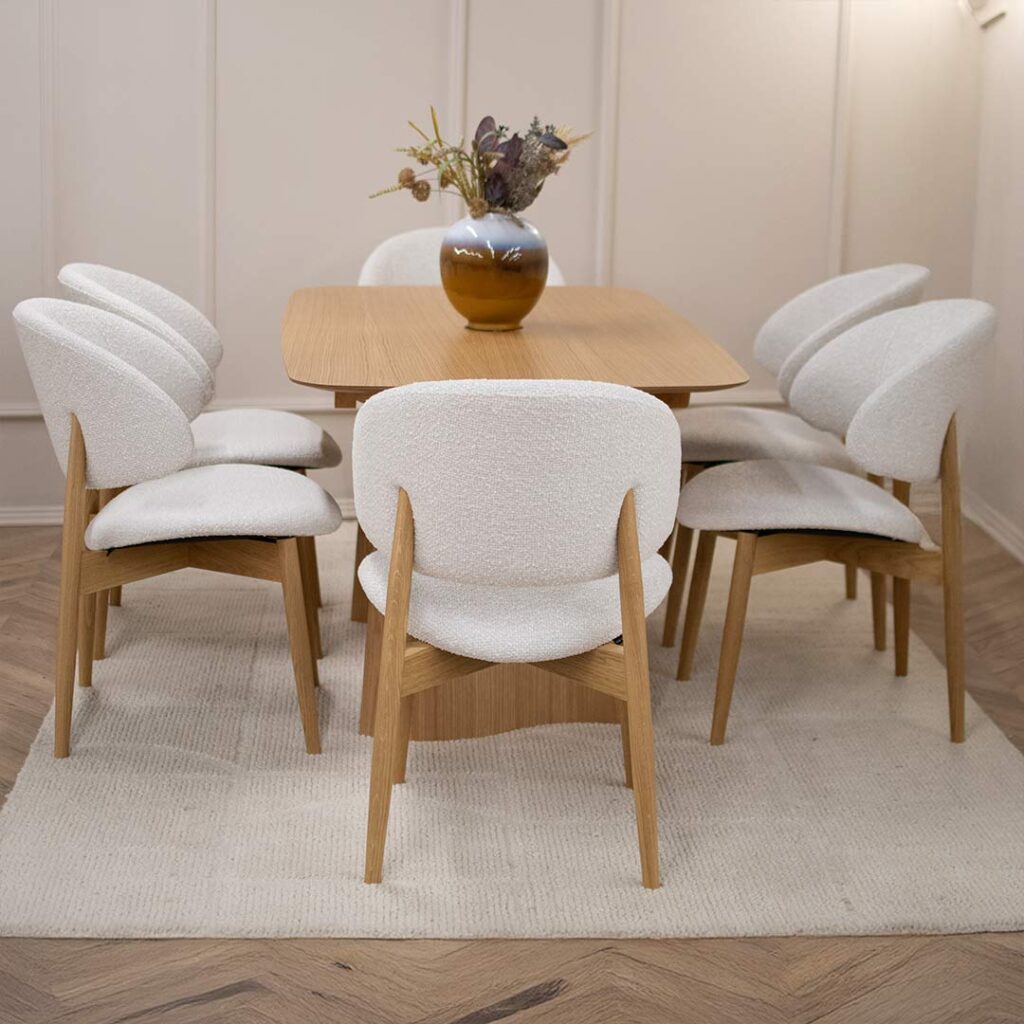Dining set with table from wood oak and dining chairs in white upholstery and oak wooden legs.