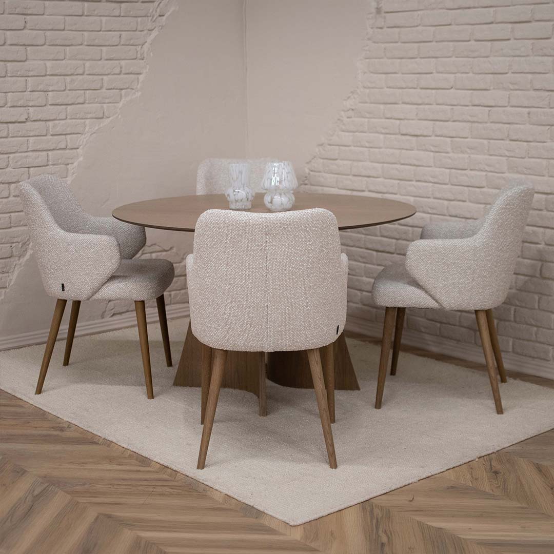 Round Astra dining table in oak with central base and upholstered dining chairs in light fabric, modern dining room interior